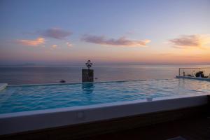 a swimming pool with a view of the ocean at La Brisa Boutique Hotel in Dhërmi