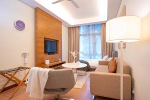 a living room with a couch and a tv in a room at 400m to KLCC Bukit Bintang Pavillion KLCC LRT walking distance in Kuala Lumpur