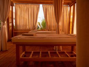 a bedroom with two beds and a window with curtains at La Brisa Boutique Hotel in Dhërmi