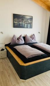 ein Bett mit lila Kissen darüber in der Unterkunft Ferienhaus Julia in Oetz