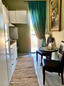 a kitchen with a table and a green curtain at top8 view in Tríkala