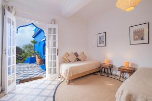 a bedroom with a bed and an open door at Villa Beldi in Essaouira