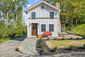 a white cottage with a pathway leading to the front door at Cozy Two Bedroom Home On Canandaigua Lake in Rushville