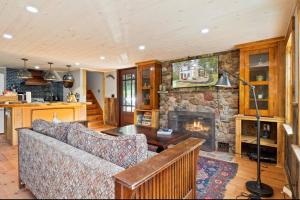 a living room with a couch and a stone fireplace at Cozy Two Bedroom Home On Canandaigua Lake in Rushville