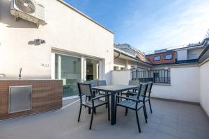 a patio with a table and chairs on a balcony at Lovag 12 Terrace Apartment in Budapest