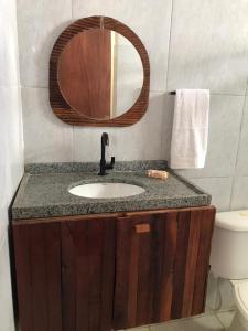 a bathroom with a sink and a mirror at Pousada da Sami in Barra de São Miguel