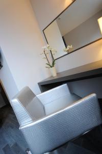 a white chair sitting next to a desk with a mirror at Park Hotel Sporting in Teramo