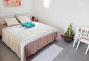 a bedroom with a bed and a table and a chair at CASA RURAL MARY in San Miguel de Abona