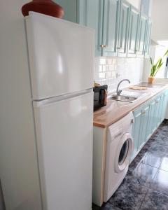 a white refrigerator in a kitchen with a washing machine at CASA RURAL MARY in San Miguel de Abona