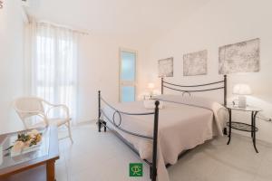 a bedroom with a bed and a table and a chair at Albatros in Capoliveri