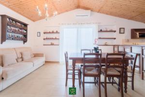 a living room with a table and chairs and a couch at Albatros in Capoliveri +64 photos