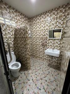 a bathroom with a toilet and a sink at บ้านสวนริมธาร โฮมสเตย์ ท้ายเหมือง พังงา 