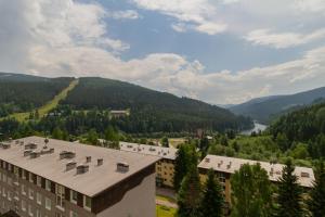 arial view of a building with mountains in the background at Residence Le Mont in Trutnov