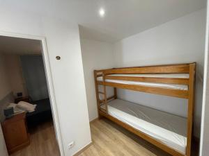 a small room with a bunk bed and a mirror at T3cab-Peyragudes-61m2-8pers in Germ +15 photos