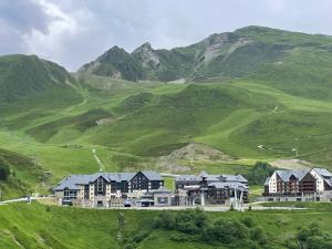 a house on a hill with mountains in the background at T3cab-Peyragudes-61m2-8pers in Germ