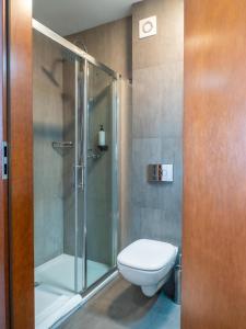 a bathroom with a toilet and a shower at B&B HOTEL Piotrków Trybunalski in Piotrków Trybunalski