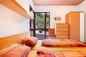 Casa Conny tesisinde bir odada yatak veya yataklar