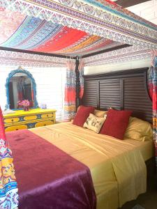 a bedroom with a large bed with a canopy at George Gardens in Ramona