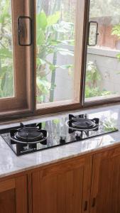 a stove top in a kitchen next to a window at Villa Gardenia Pantai Jepara in Jepara