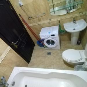 a bathroom with a toilet and a sink at العين الهيلي مصباح بيت 8 in Al Ain