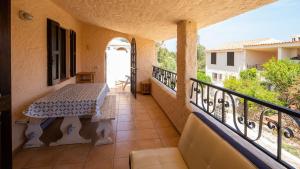 a balcony of a house with a table on it at Appartamenti Agrustos in Budoni