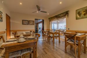 a dining room with wooden tables and chairs at Villas D. Dinis - Charming Residence (adults only) in Lagos