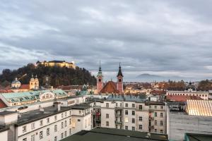 a view of a city with buildings and a hill at Eurostars uHOTEL in Ljubljana