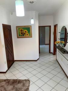 a kitchen with a tile floor and a picture on the wall at Casa prox á praia e aeroporto in Florianópolis