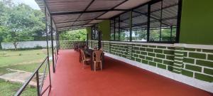 a room with tables and chairs in a building at Wild tusker in Masinagudi