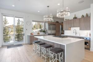 a kitchen with a large white island with bar stools at Quicksilver Haus in Park City