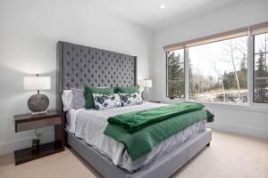 a bedroom with a large bed and a window at Quicksilver Haus in Park City