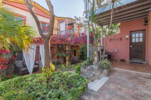 a house with a courtyard with flowers and plants at Villas D. Dinis - Charming Residence (adults only) in Lagos