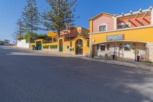 a yellow building on the side of a street at Villas D. Dinis - Charming Residence (adults only) in Lagos