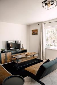 a living room with a couch and a table at Apartment in Seenähe in Berlin