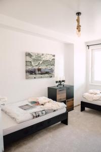a bedroom with two beds and a painting on the wall at Apartment in Seenähe in Berlin