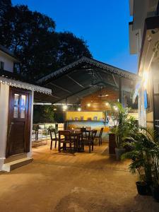 a patio with a table and chairs on it at Aaria Hills in Arambol