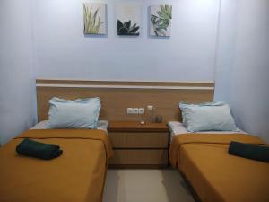 Ένα ή περισσότερα κρεβάτια σε δωμάτιο στο Merendeng Hostel Kuta