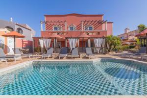 a swimming pool in front of a building at Villas D. Dinis - Charming Residence (adults only) in Lagos