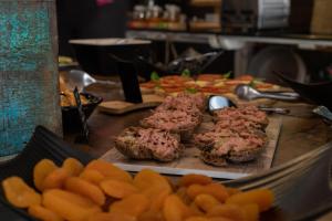 a buffet of food with meat and vegetables on a table at Villas D. Dinis - Charming Residence (adults only) in Lagos