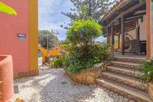 a building with stairs and plants in front of it at Villas D. Dinis - Charming Residence (adults only) in Lagos