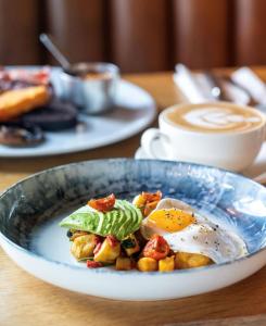 a bowl of food with an egg on a table at The Pier Hotel in Harwich