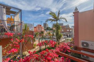 a balcony with pink flowers on a building at Villas D. Dinis - Charming Residence (adults only) in Lagos
