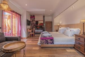 a hotel room with a bed and a couch at Villas D. Dinis - Charming Residence (adults only) in Lagos