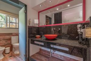 a bathroom with a sink and a red bowl at Villas D. Dinis - Charming Residence (adults only) in Lagos