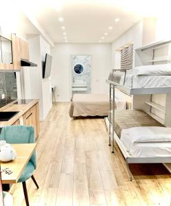 a room with two bunk beds and a desk at Perugia Family Flat in Perugia