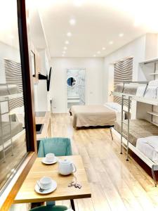 a room with two beds and a table with plates on it at Perugia Family Flat in Perugia