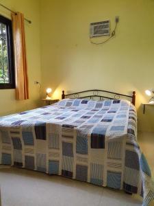 a large bed in a room with at Regina's Vacation House in Tayud