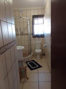 a small bathroom with a toilet and a window at Raiden's Home in Saldanha