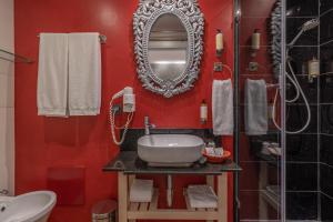 a red bathroom with a sink and a mirror at Villas D. Dinis - Charming Residence (adults only) in Lagos