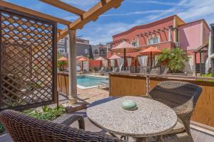a patio with a table and chairs and a pool at Villas D. Dinis - Charming Residence (adults only) in Lagos